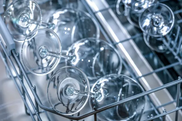 Wine glasses in the upper rack of a dishwasher