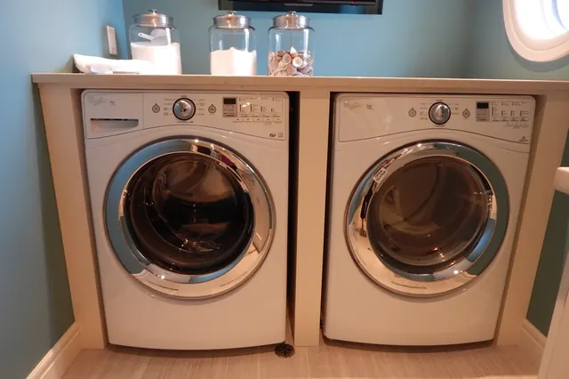 Home laundry room with a front-load washer and dryer side by side